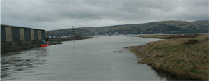 The dyke and the river Leri at Ynyslas boatyard and the Dyfi estuary